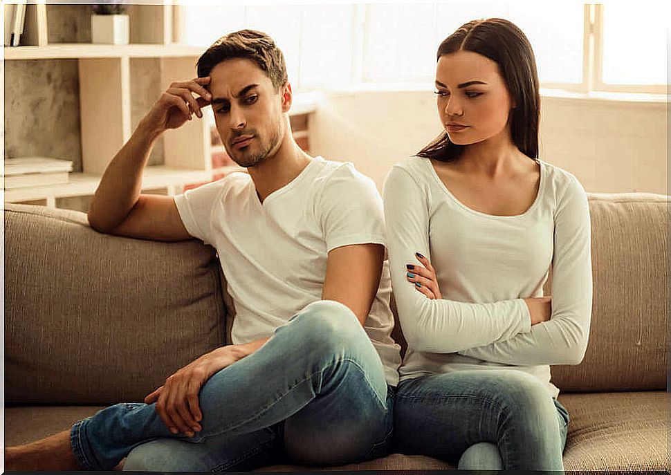 Angry couple sitting on the couch.