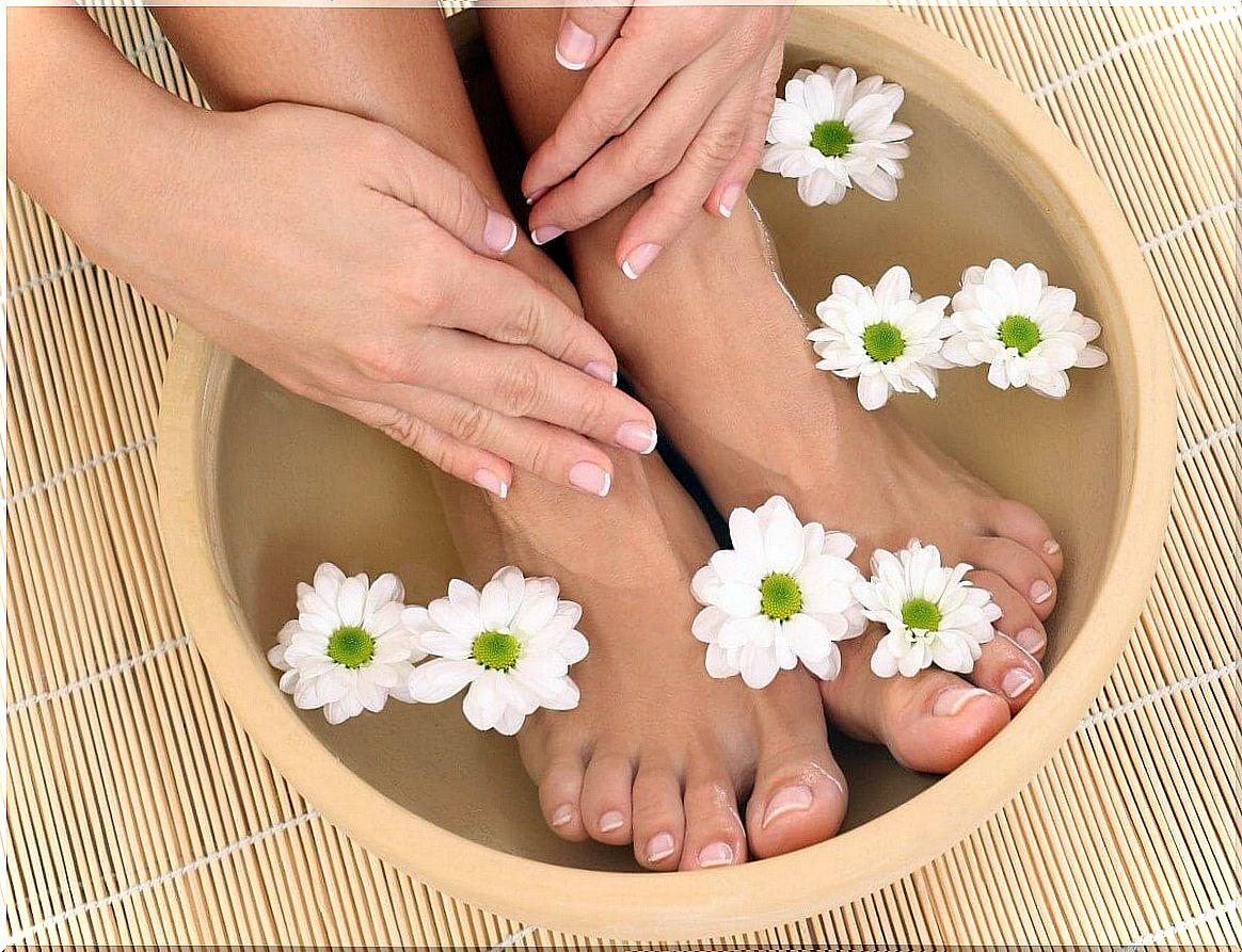 Woman taking a foot bath with water and salt.