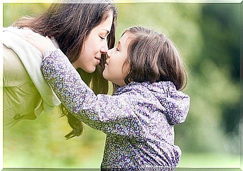 Daughter giving her mother a kiss as part of the process to recognize emotions.